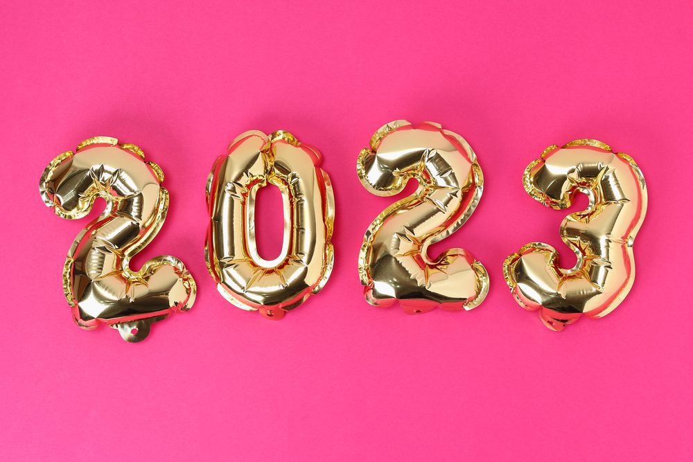 New Year 2023. Foil balloons numbers 2023 on pink background. New Year Christmas.
