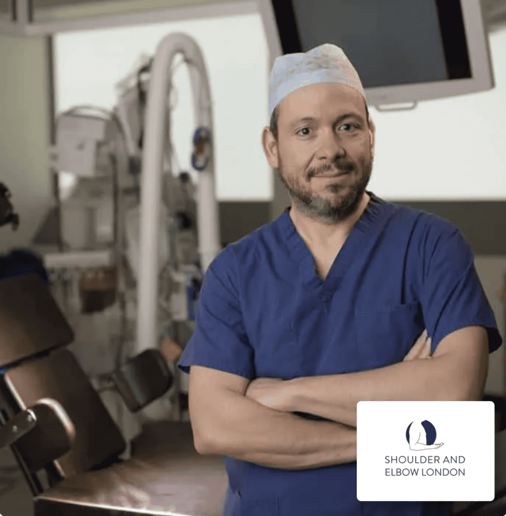 Shoulder and Elbow London clinician in surgical scrubs with clinic logo