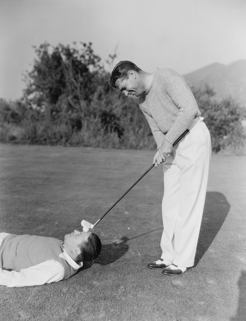 Man hitting golf ball on mans forehead website design